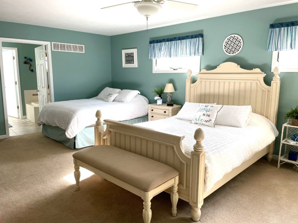 Master Bedroom: Relax in comfort with a queen bed, double bed, 32” TV, and convenient charging stations on the nightstands.