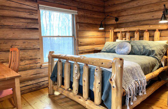 Bedroom #1: main floor private bedroom furnished with a queen bed and workstation for your remote working needs; a clock with USB and outlets to charge your devices