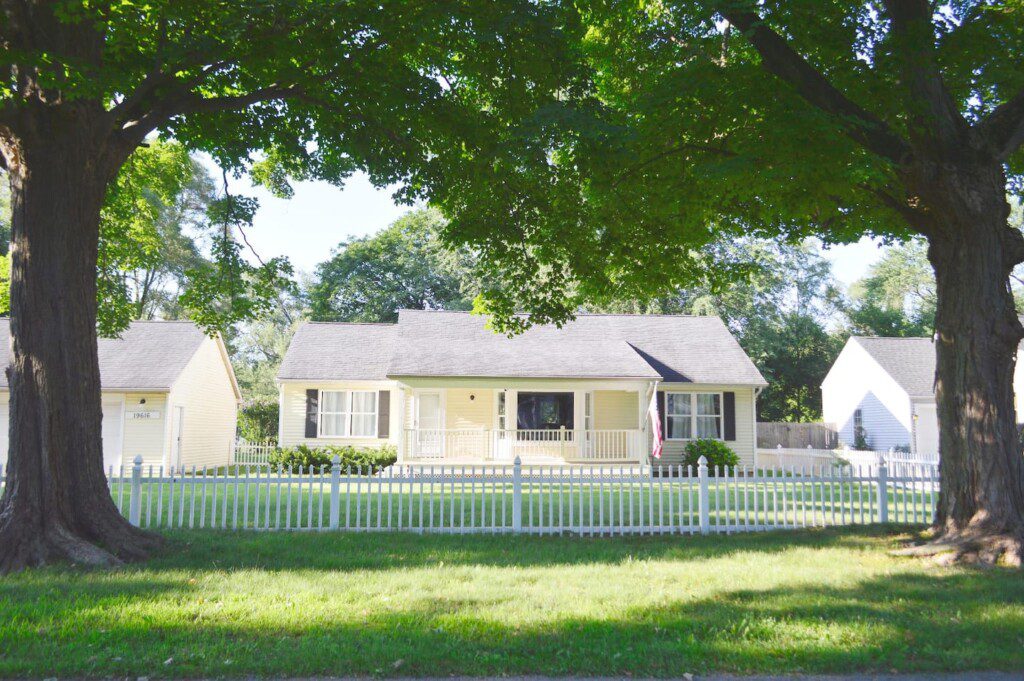 White picket fence surrounding the front yard! This is the view from road
