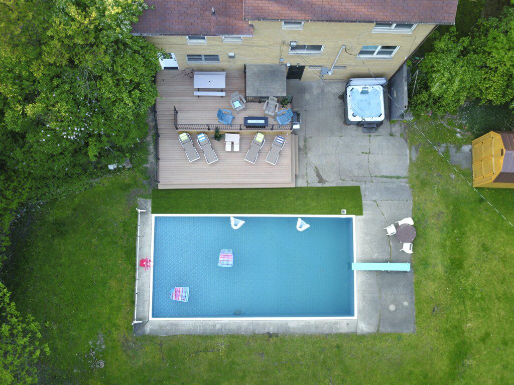 Family Fun at Riverside Pool Paradise! Splash in the pool, relax in the hot tub, or enjoy yard games. Spacious deck with seating! Toddler cabana, & custom art.