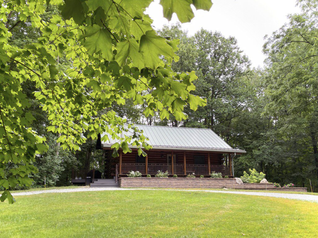Trillium Lane Cabin - sit back and relax to enjoy nature all around you on the front porch in complete seclusion. Hot tub out walkout basement; outdoor fireplace (not pictured)