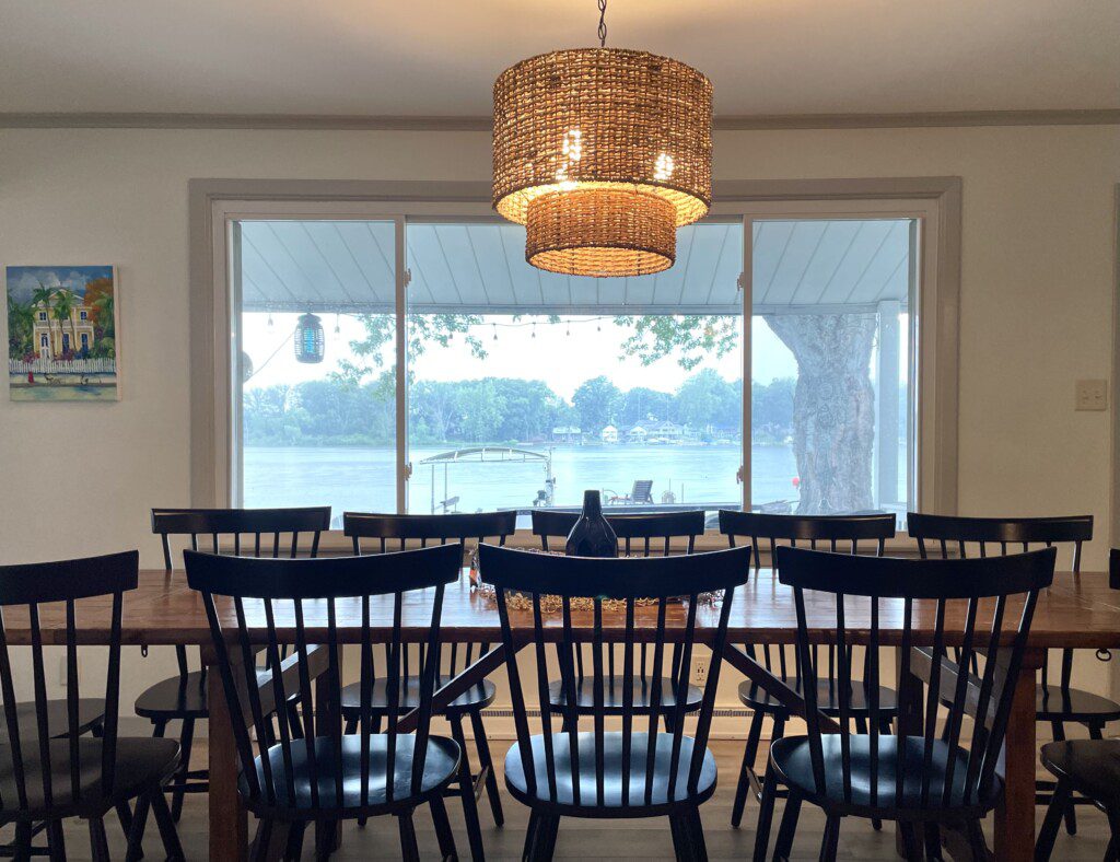 The Waldron Lake Retreat Dining Room: a large dining room table and chairs with a large window to take in the sights of the lake