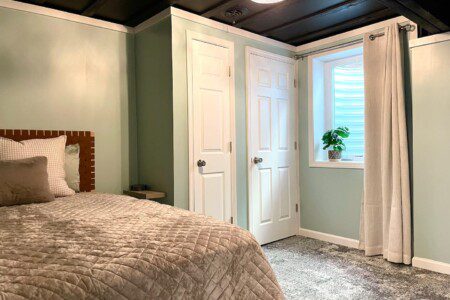 Basement Bedroom with two queen beds; nightstand a clocks w/ USB and outlets to make charging devices super convenient