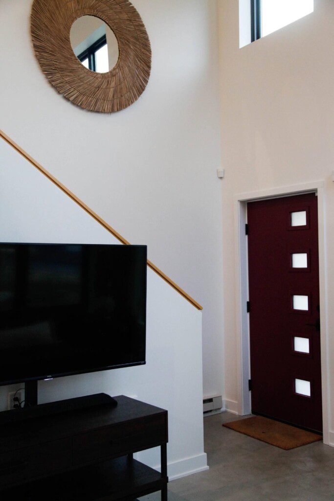 Living Room and Front Door. Enjoy this 55" TCL Roku Smart TV