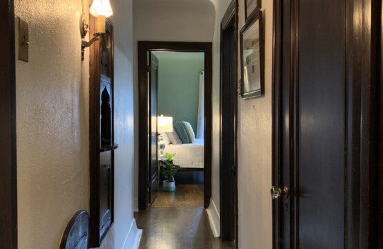 Hallway leading to main floor bathroom and two bedrooms