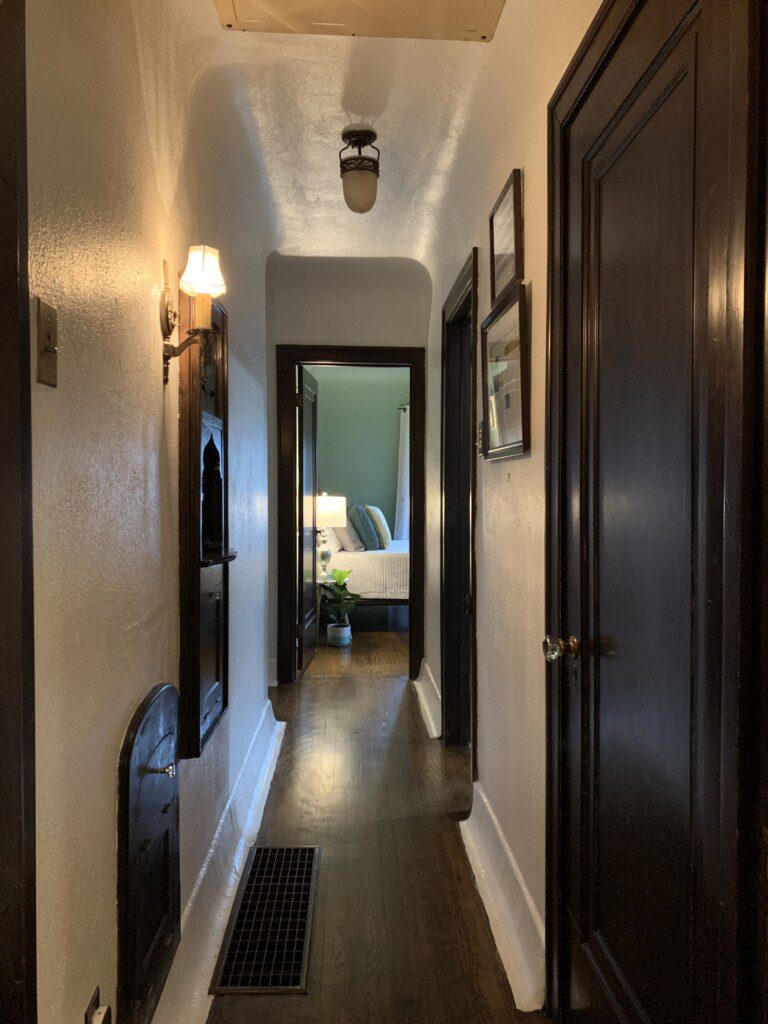 Hallway leading to main floor bathroom and two bedrooms