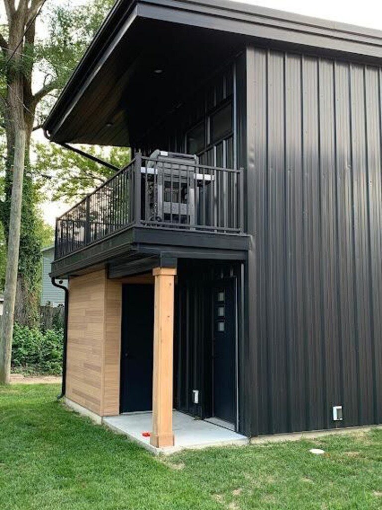 Back of property - view of back entrance and balcony off the upstairs bedroom. There is also a carport for easy/safe parking (not pictured).