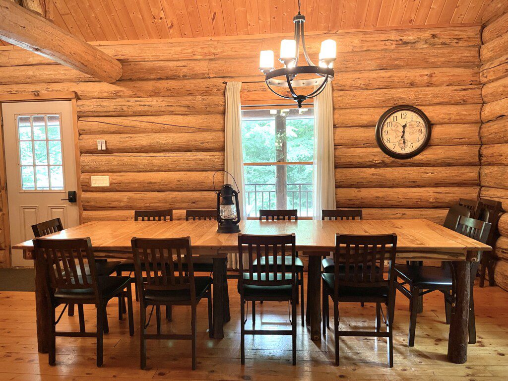 Trillium Lane Cabin Dining Room - enjoy the quiet ambiance of the open concept log cabin in the comfortable living room, or enjoy a movie on the 50" Roku Smart TV