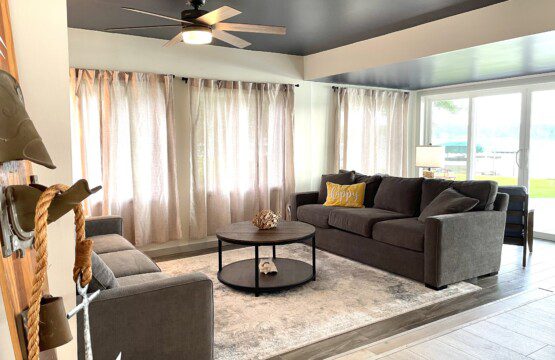 Waldron Lake Retreat: Experience ultimate relaxation in our open-concept living and sitting rooms, featuring stunning lake views. Enjoy your favorite shows on the Roku TV with YouTube TV (TV not pictured).