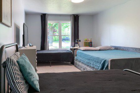 Master Bedroom - queen day bed (pull-out twin) with two other twins; all 3 twin beds are rated for adults. Large RokuTV with a Super Nintendo preloaded with 20 games on the dresser.