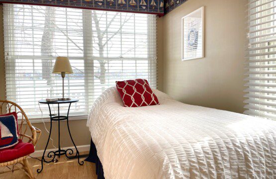 Bedroom #2: A cozy retreat with a double bed, twin bed, and a nightstand with a charging station for your convenience.