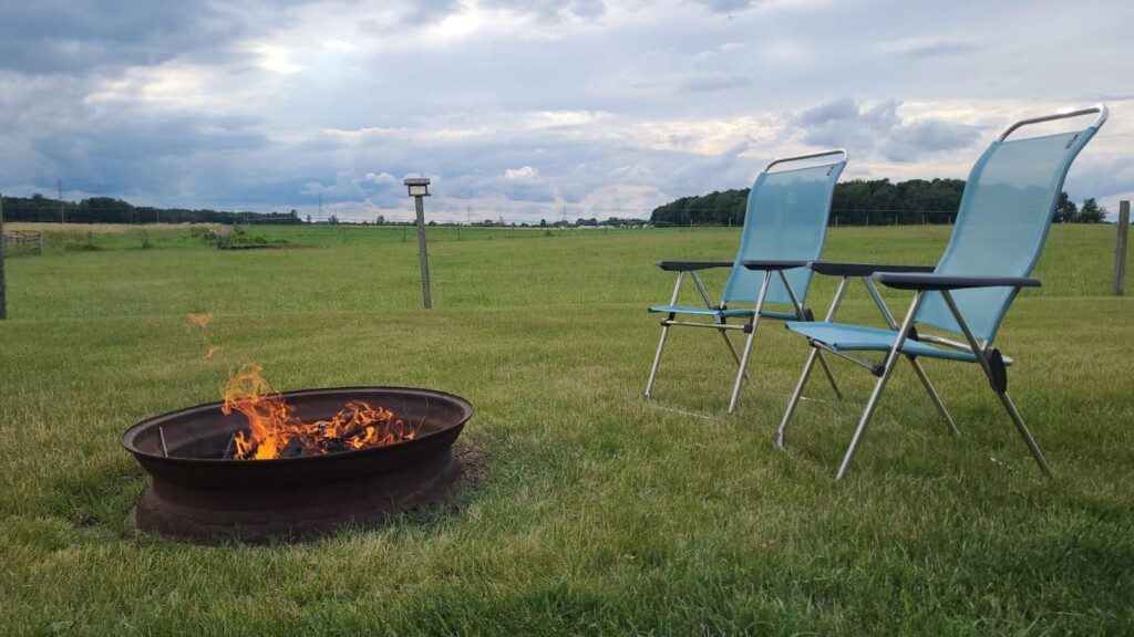 Can't you see yourself relaxing around the fire in a beautiful country setting? Complimentary firewood and chairs!