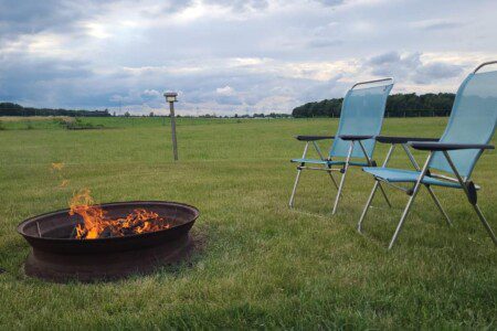 Can't you see yourself relaxing around the fire in a beautiful country setting? Complimentary firewood and chairs!