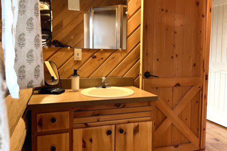 Bathroom #1: main floor bathroom with shower cabin furnished with towels, wash clothes, shampoo, and soap