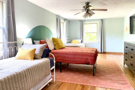 Bedroom #1 with highly rated Lucid queen mattress, and 4 twin beds; a clock w/ USB and outlets to make charging devices super convenient; 43" Roku Smart TV, ceiling fan