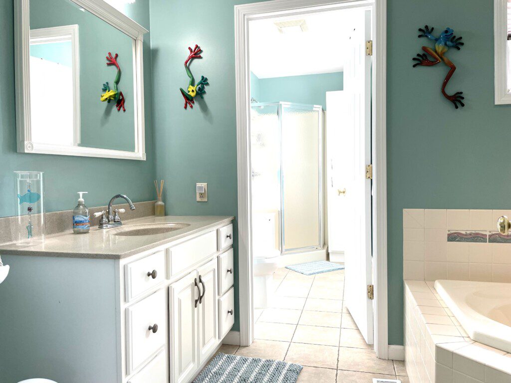 Master Bathroom: Cabin shower, separate large corner bathtub, stocked with towels, soap, and shampoo