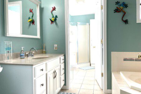Master Bathroom: Cabin shower, separate large corner bathtub, stocked with towels, soap, and shampoo