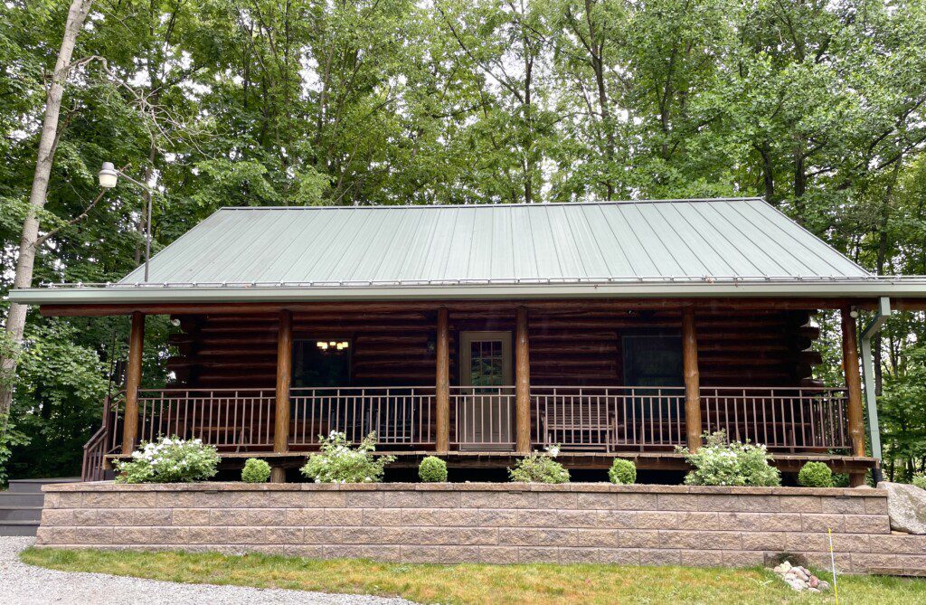 Trillium Lane Cabin - sit back and relax to enjoy nature all around you on the front porch in complete seclusion. Hot tub out walkout basement; outdoor fireplace (not pictured)