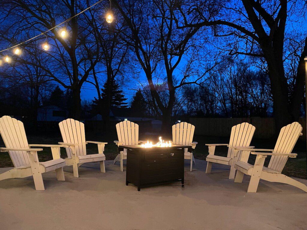 Cozy up by the firepit and enjoy the warmth under the twinkling lights—perfect for a relaxing evening with friends and family.