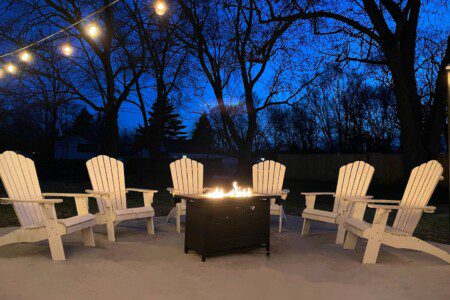 Cozy up by the firepit and enjoy the warmth under the twinkling lights—perfect for a relaxing evening with friends and family.