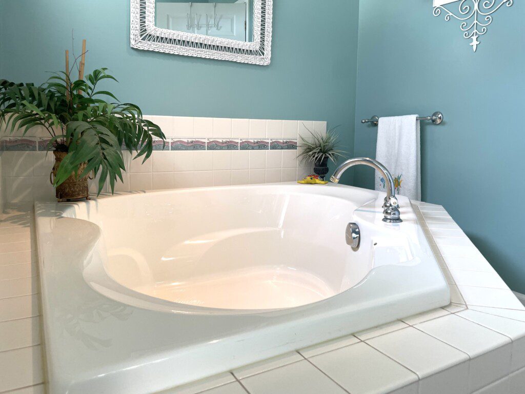 Master Bathroom: Cabin shower, separate large corner bathtub, stocked with towels, soap, and shampoo