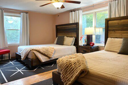 Bedroom #2 with two highly rated Lucid queen mattresses, a clock w/ USB and outlets to make charging devices super convenient; 43" Roku Smart TV, ceiling fan