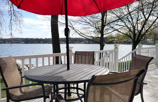 Relax under the umbrella on the back deck, perfect for meals or sipping drinks while soaking in the lake views.