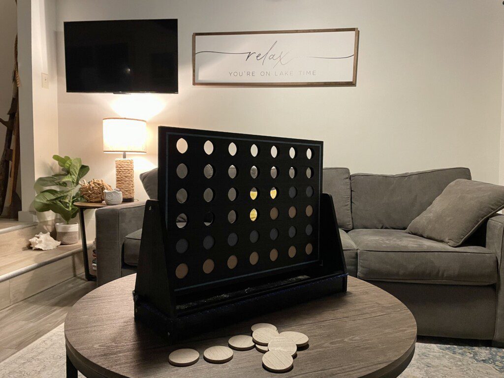 Waldron Lake Retreat: Experience ultimate relaxation in our open-concept living and sitting rooms, featuring stunning lake views. Enjoy your favorite shows on the Roku TV with YouTube TV.