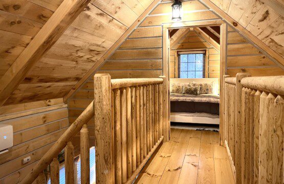Sleep comes easy here! This timber walkway connects both upstairs bedrooms, offering woodsy charm and a peaceful retreat for the whole family.