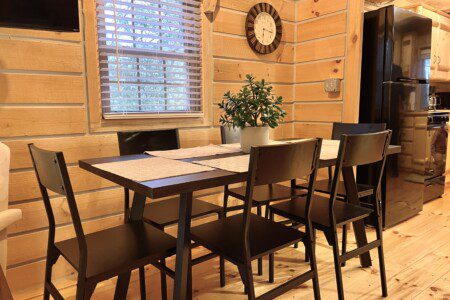 🍽️ Gather and share meals or laughter at this cozy dining table, perfect for family dinners and game nights in your log cabin retreat!