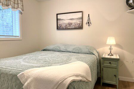 Stone Lake Cottage Retreat: Queen bed + charging nightstand = restful and ready for tomorrow.
