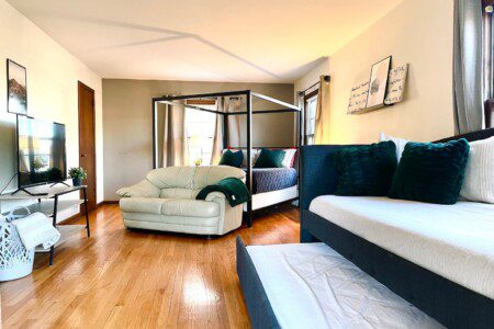 Upstairs Bedroom #2 - with highly rated Lucid queen mattress; a clock w/ USB and outlets to make charging devices super convenient; 43" Roku Smart TV; Daybed for comfortable seating & sleeping with pull-out twin bed underneath.