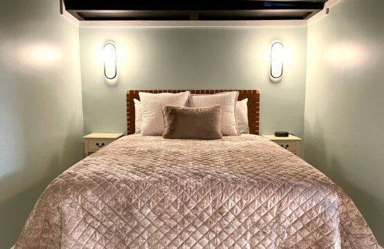 Basement Bedroom with two queen beds; nightstand a clocks w/ USB and outlets to make charging devices super convenient