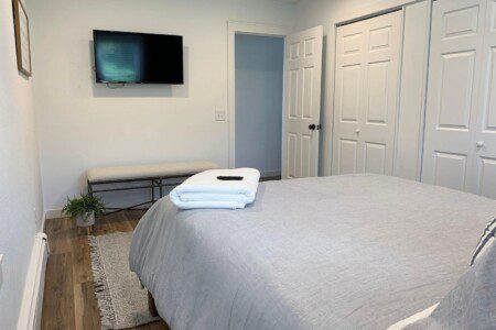 Bedroom #1 comfortable queen bed that has a 40" TCL Roku TV with complimentary YouTubeTV Access (cable-like TV); USB clock right beside the bed for all your charging needs