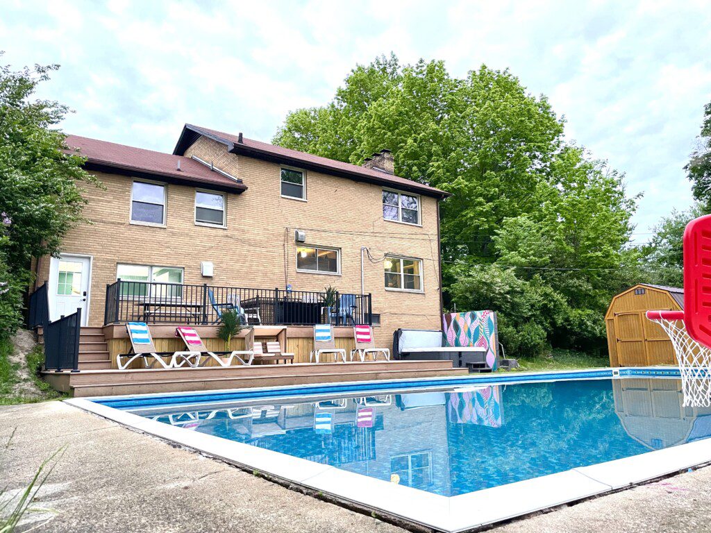 Family Fun at Riverside Pool Paradise! Splash in the pool, relax in the hot tub, or enjoy yard games. Spacious deck with seating! Toddler cabana, & custom art.