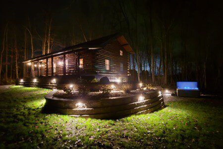 Our log cabin under the lights! Enjoy the hot tub late into the evening under the lights! 