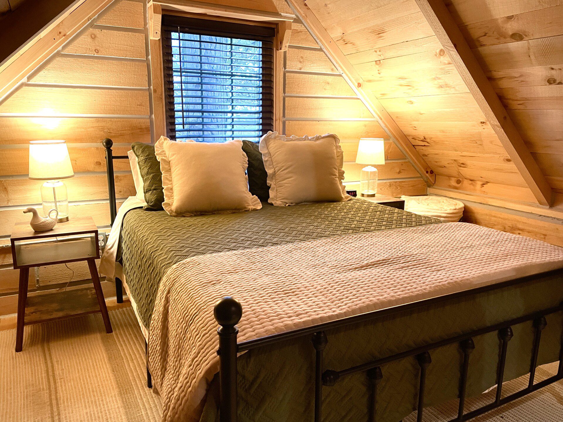 🛏️ Retreat to Upstairs Bedroom #1—queen bed, soft linens, fluffy pillows, and a USB outlet on the nightstand for charging. The perfect log cabin haven for a restful night’s sleep! 🌙🔌