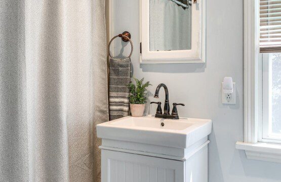 Upstairs bathroom with shower and tub combination.