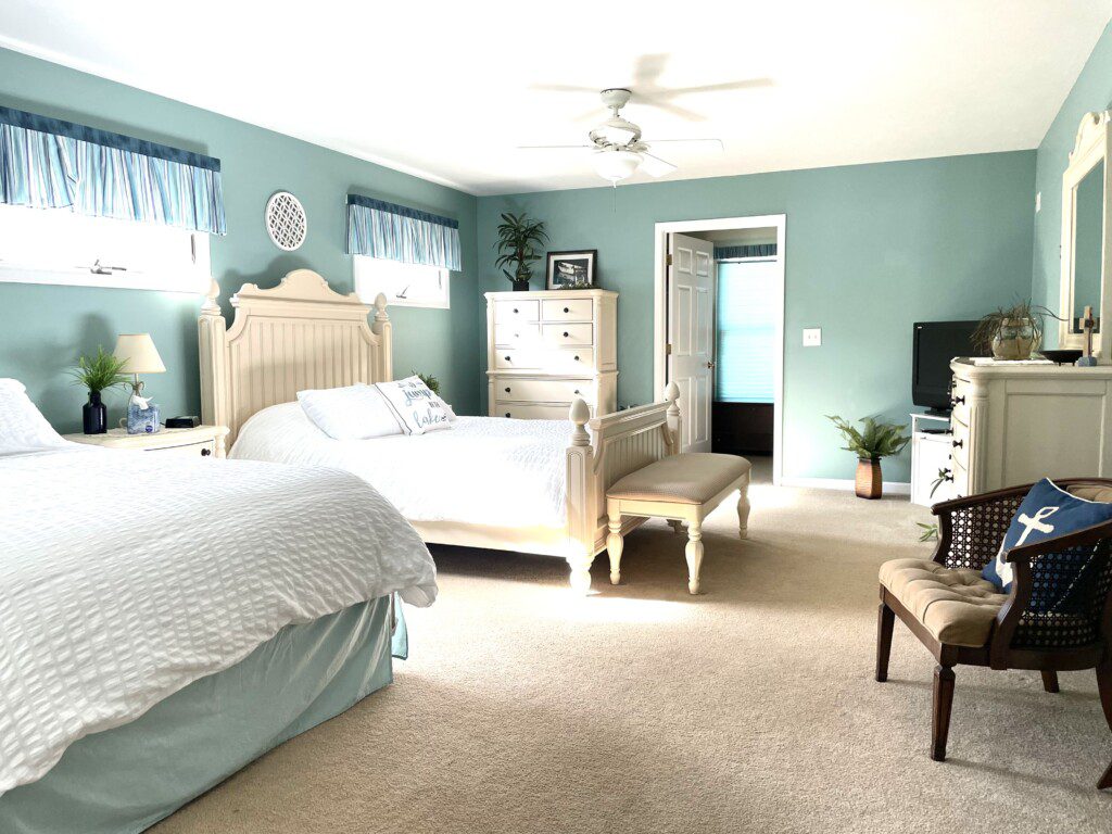 Master Bedroom: Relax in comfort with a queen bed, double bed, 32” TV, and convenient charging stations on the nightstands.