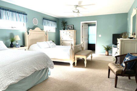 Master Bedroom: Relax in comfort with a queen bed, double bed, 32” TV, and convenient charging stations on the nightstands.