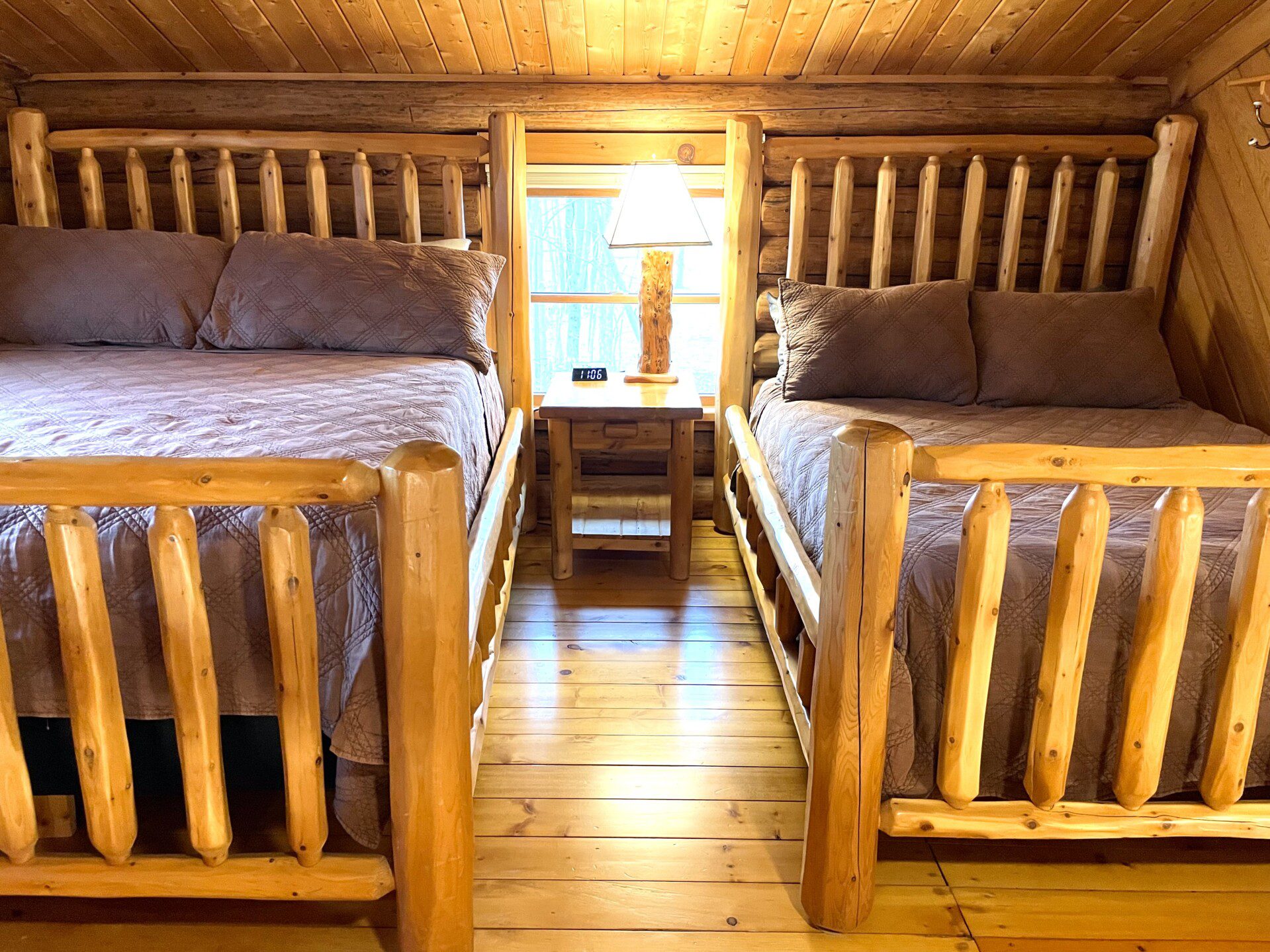 Bedroom #2: upstairs - two beds in room (one queen and one full) & easy charging stations beside beds; open loft design - an airy, connected space overlooking the rest of the cabin, though not a private room.