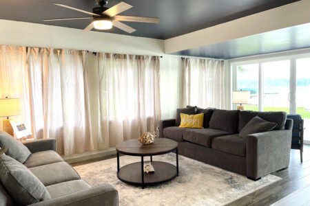 Waldron Lake Retreat: Experience ultimate relaxation in our open-concept living and sitting rooms, featuring stunning lake views. Enjoy your favorite shows on the Roku TV with YouTube TV (TV not pictured).