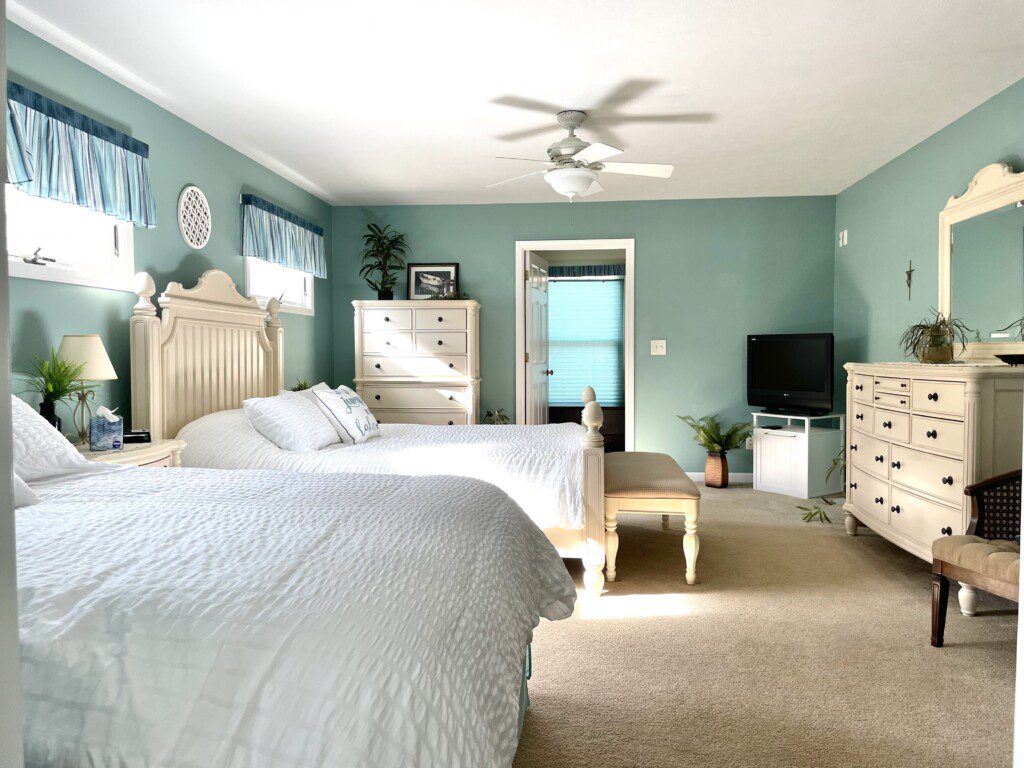 Master Bedroom: Relax in comfort with a queen bed, double bed, 32” TV, and convenient charging stations on the nightstands.