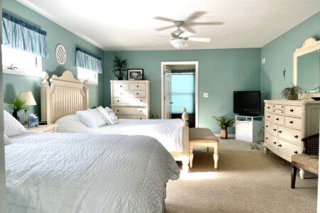 Master Bedroom: Relax in comfort with a queen bed, double bed, 32” TV, and convenient charging stations on the nightstands.