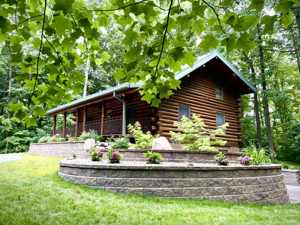 Trillium Lane Cabin - sit back and relax to enjoy nature all around you on the front porch in complete seclusion. Hot tub out walkout basement; outdoor fireplace (not pictured)