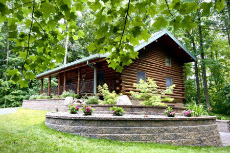 Trillium Lane Cabin - sit back and relax to enjoy nature all around you on the front porch in complete seclusion. Hot tub out walkout basement; outdoor fireplace (not pictured)