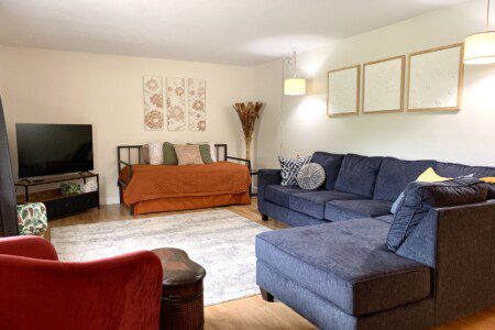 Living Room with 55" Roku Smart TV. Enjoy the comfortable, unique, and retro sofa options. Need extra sleeping space? Comfortable day bed with trundle!