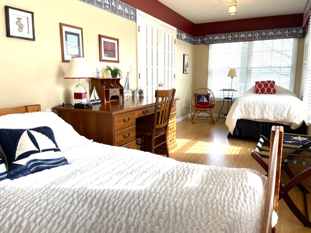 Bedroom #2: A cozy retreat with a double bed, twin bed, and a nightstand with a charging station for your convenience.