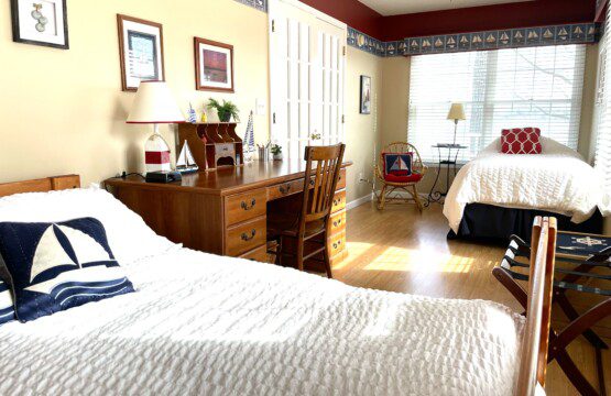 Bedroom #2: A cozy retreat with a double bed, twin bed, and a nightstand with a charging station for your convenience.