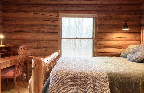 Bedroom #1: main floor private bedroom furnished with a queen bed and workstation for your remote working needs; a clock with USB and outlets to charge your devices